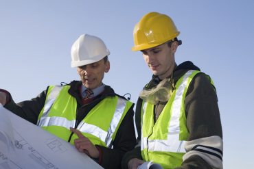 Builders looking at paperwork
